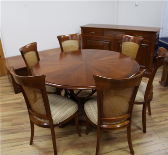 A 20th century French cherrywood radially extending dining table, the circular table extends to 6ft 7in.